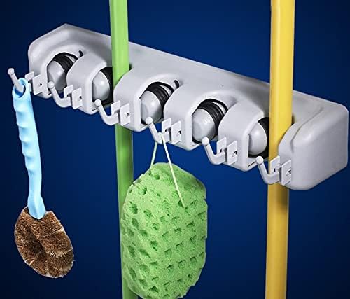 Wall mounted broom and mop holder organizer with 5 slots and 6 hooks for storing cleaning tools neatly and securely