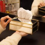 Luxury decorative mirror glass tissue box with European Nordic design placed on a modern living room table