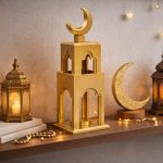 Gold medium tower minaret Ramadan decoration with moon displayed next to a TV in a modern living room