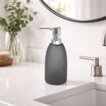 Modern 400ml plastic liquid soap dispenser with pump placed on a bathroom sink countertop