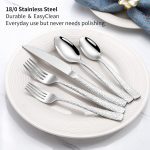 stainless steel 30-piece cutlery set with mirror finish including forks, spoons and knives arranged around dining plate