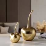 Oversized gold cherrie decorative sculpture with metallic finish displayed on a modern side table – elegant glam home accent from Homedash Lebanon.