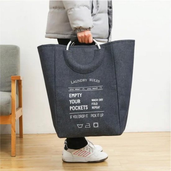 laundry basket with soft grip handles and laundry inside on white background