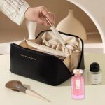 cosmetic bag made of waterproof PU leather with multi-layer compartments and wide opening for travel and daily use.