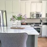 Modern off-white ceramic round vase with matte textured finish, styled with dried flowers for contemporary home decor centerpiece