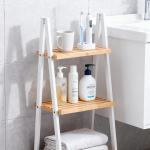 3 tier wooden organizer ladder shelf with natural wood shelves and black legs used for plant display and home storage