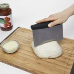 dough scraper with black ergonomic handle and measurement markings for baking and kitchen use