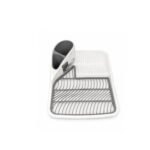Plastic dish drainer with cutlery holder and draining spout on white background