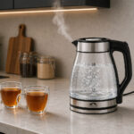 Momaz 1.5L glass electric kettle with steam from nozzle on white background