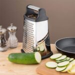 4-sided stainless steel box grater with handle and anti-slip base for slicing and grating vegetables and cheese