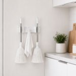 wall mounted holder for mops and brooms with 2 grips and hook