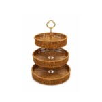 rattan basket stand for fruit and snacks with gold handle on display