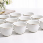 Set of 12 white ceramic coffee cups with elegant gold rim on white background