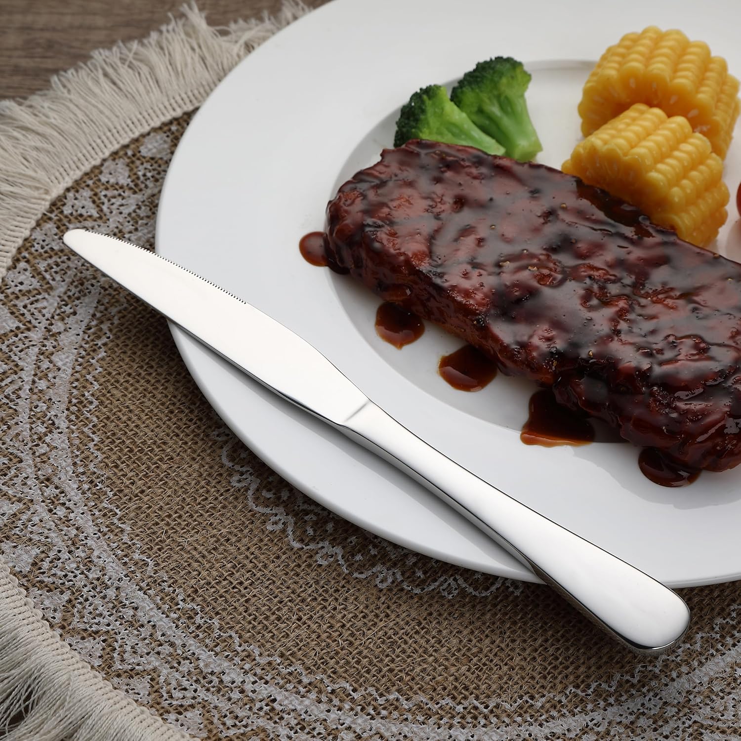 Set of 3 stainless steel dinner knives with ergonomic handle on white background