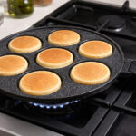 Dosthoff non-stick pancake pan with 7 holes cooking pancakes on stove