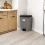plastic pedal dustbin with black lid and removable inner bucket with handle for kitchen and home use.