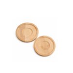 Two round natural bamboo coasters with hot glass tea cups on a modern living room side table