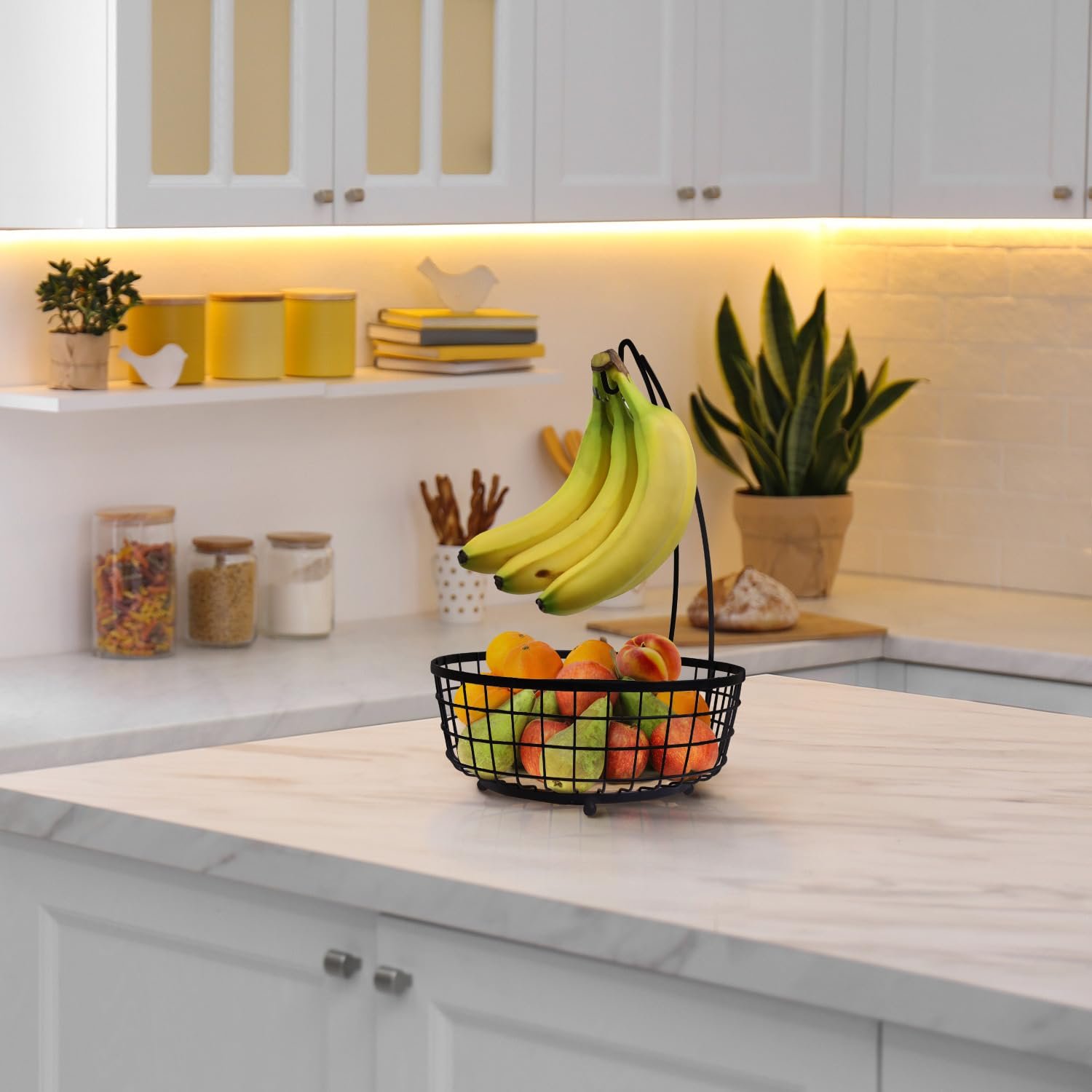metal fruit bowl with banana tree hanger and bamboo wood base for kitchen countertop organization.