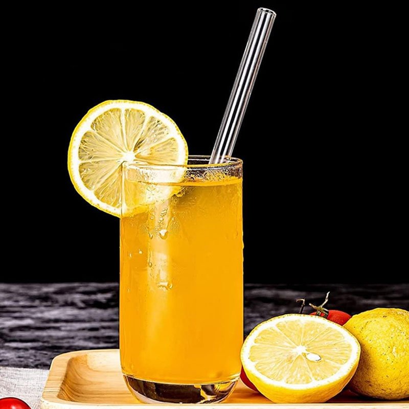 Reusable clear glass smoothie straws with cleaning brush for juice milkshakes and iced drinks on white background in Lebanon