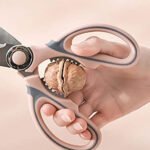 Stainless steel kitchen scissors with protective cover, soft-grip handles, available in pink and green colors,