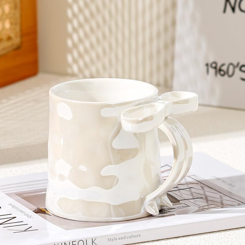 ceramic mug with textured finish and light blue 3D ribbon handle for coffee and tea.