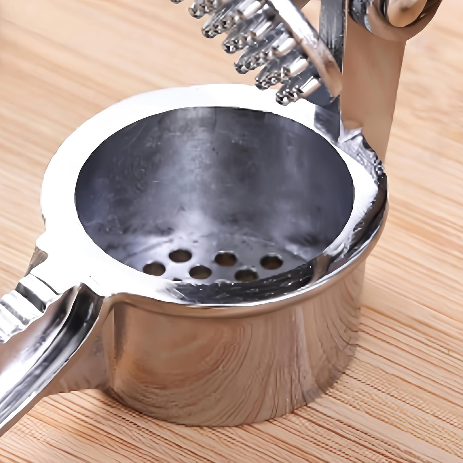 Curved stainless steel garlic and ginger crusher press dishwasher safe kitchen tool 15 cm long.