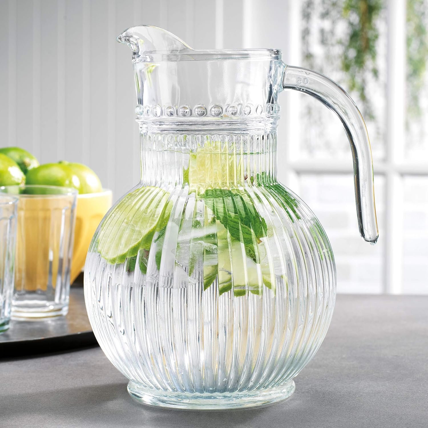 Ribbed glass pitcher with plastic lid and handle,