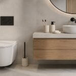 Modern beige cement bathroom accessory set with soap dispenser, toothbrush holder, soap dish, and toilet brush holder on white background.
