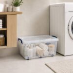 Transparent 30-liter BPA-free plastic storage box with secure clip-lock lid, six wheels, and blue handles for easy home organization and storage.