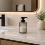 glass soap dispenser with matte black pump for bathroom or kitchen countertop use.