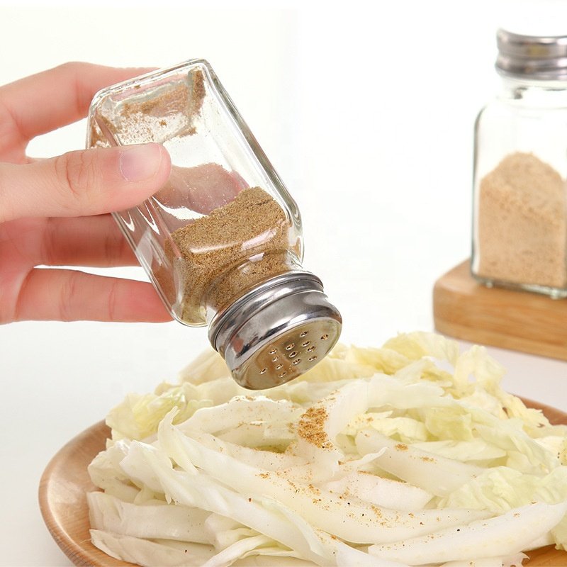 glass salt shaker with a stainless steel screw-on lid and spice dispensing holes