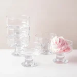 set of six 265ml clear footed glass dessert bowls, ideal for serving ice cream, puddings, fruit, salads, and snacks.