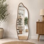 Irregular full-length standing mirror with wood frame and black metal stand